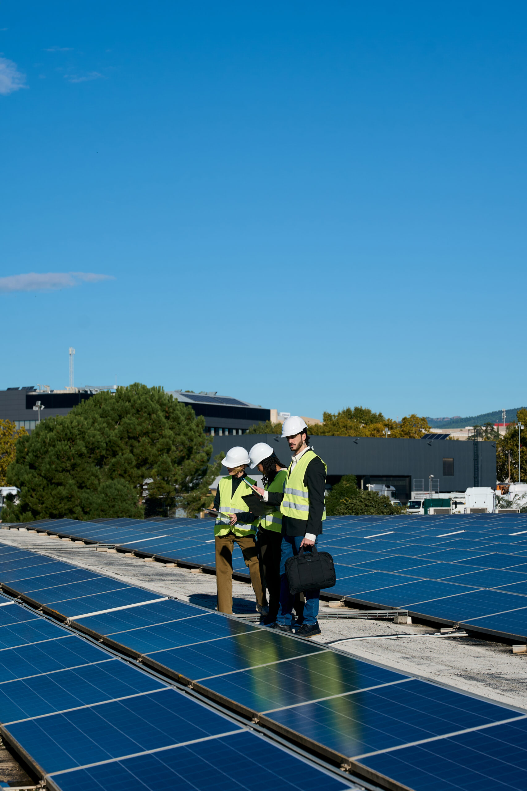 Engineers team inspecting rooftop solar panels on building